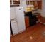 Functional kitchen with essential appliances, oak cabinets, and wood flooring at 6579 Alford Way, Lithonia, GA 30058