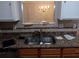 A double-basin kitchen sink with stainless steel faucet, granite countertops, and tiled backsplash at 6579 Alford Way, Lithonia, GA 30058