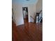 An open-concept living room with rich wood floors leading to the kitchen and staircase at 6579 Alford Way, Lithonia, GA 30058