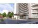 View of building's main entrance with portico and manicured landscaping at 2660 Peachtree Nw Rd # 18G, Atlanta, GA 30305