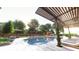 Beautiful pool and lounge area with mature trees and sunshades offering an oasis for relaxation at 2660 Peachtree Nw Rd # 18G, Atlanta, GA 30305