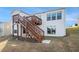 Exterior home view showing a backyard with wood stairs and a deck that provides outdoor access to the second story at 5810 Collier Bridge Ln, Hoschton, GA 30548