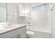 Clean bathroom featuring a tub/shower combo, white cabinets, and a modern sink at 5810 Collier Bridge Ln, Hoschton, GA 30548