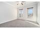 Spacious bedroom featuring plush gray carpeting and large windows with picturesque views at 5810 Collier Bridge Ln, Hoschton, GA 30548