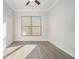 Cozy bedroom with modern ceiling fan, hardwood floors, and ample natural light at 5810 Collier Bridge Ln, Hoschton, GA 30548