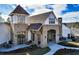 Beautiful stone and brick clubhouse featuring an arched entryway and inviting outdoor seating areas at 5810 Collier Bridge Ln, Hoschton, GA 30548