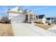 Attractive home featuring a spacious driveway, a covered porch and meticulous landscaping at 5810 Collier Bridge Ln, Hoschton, GA 30548