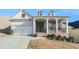 Beautiful home with an inviting front porch, brick accents, and a well-maintained lawn at 5810 Collier Bridge Ln, Hoschton, GA 30548