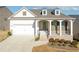 Charming single-story home featuring a welcoming front porch and a two-car garage at 5810 Collier Bridge Ln, Hoschton, GA 30548