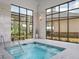 Indoor hot tub with large windows and seating, offering a relaxing space for residents to unwind at 5810 Collier Bridge Ln, Hoschton, GA 30548