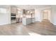 Modern kitchen with stainless steel appliances, grey cabinets, island, and stylish backsplash at 5810 Collier Bridge Ln, Hoschton, GA 30548