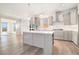 Bright, modern kitchen with grey cabinets, island with seating, and stainless steel appliances at 5810 Collier Bridge Ln, Hoschton, GA 30548