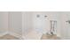 A light and airy laundry room with white walls and light colored tile flooring at 5810 Collier Bridge Ln, Hoschton, GA 30548