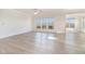 Bright living room featuring hardwood floors, natural light, and views of the outdoor landscape at 5810 Collier Bridge Ln, Hoschton, GA 30548