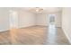 Spacious living room with ceiling fan, wood-look floors, and ample natural light at 5810 Collier Bridge Ln, Hoschton, GA 30548