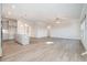 Open-concept living room and kitchen with sleek island and modern light fixtures at 5810 Collier Bridge Ln, Hoschton, GA 30548