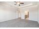 Large main bedroom with tray ceiling, fan, and ensuite bathroom entrance at 5810 Collier Bridge Ln, Hoschton, GA 30548