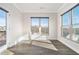 Sunlit room with large windows offering scenic outdoor views and hardwood style flooring at 5810 Collier Bridge Ln, Hoschton, GA 30548