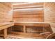 The inside of a wood-paneled sauna with wood benches and a bucket with a ladle at 5810 Collier Bridge Ln, Hoschton, GA 30548