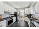 Modern kitchen with stainless steel appliances, granite countertops, and dark slate flooring at 701 Glenwood Se Ave, Atlanta, GA 30312