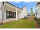 A covered patio is shown in a backyard with green grass, an AC unit, and a metal fence at 509 Pearl St, Cumming, GA 30040
