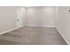 Spacious carpeted basement room with an interior door and neutral wall paint at 509 Pearl St, Cumming, GA 30040