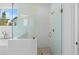 Modern bathroom featuring a glass shower with white tile and a window view at 509 Pearl St, Cumming, GA 30040