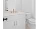Bathroom with white cabinets, gold hardware and a toilet at 509 Pearl St, Cumming, GA 30040