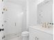 Bathroom featuring a glass shower, white tile and a modern vanity with bronze fixtures at 509 Pearl St, Cumming, GA 30040