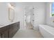 Elegant bathroom features a double vanity, a freestanding tub, and modern fixtures at 509 Pearl St, Cumming, GA 30040