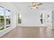 Bright bedroom features hardwood floors, tray ceilings, recessed lighting, and large windows at 509 Pearl St, Cumming, GA 30040