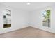 Bright and airy bedroom with light wood floors and large windows with neighborhood views at 509 Pearl St, Cumming, GA 30040