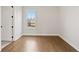 Bright bedroom with hardwood floors and a large window at 509 Pearl St, Cumming, GA 30040