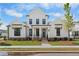 Inviting two-story home boasting a white facade, black window trim, complemented by a well-manicured lawn at 509 Pearl St, Cumming, GA 30040