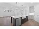Bright, open kitchen features a central island with a farmhouse sink and stainless steel dishwasher at 509 Pearl St, Cumming, GA 30040