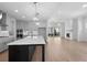 Open-concept kitchen with gray cabinets, stainless steel appliances, and a large center island at 509 Pearl St, Cumming, GA 30040