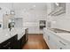 Modern kitchen featuring white cabinets, quartz countertops, and a farmhouse sink at 509 Pearl St, Cumming, GA 30040
