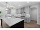 Well-lit kitchen with grey cabinets, stainless steel appliances, and a large marble-topped island at 509 Pearl St, Cumming, GA 30040