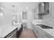 Modern kitchen features gray cabinets, stainless steel appliances, and a spacious island with a farmhouse sink at 509 Pearl St, Cumming, GA 30040
