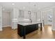 Spacious kitchen with a large island, white cabinetry, and quartz countertops at 509 Pearl St, Cumming, GA 30040