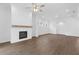 Spacious living room features hardwood floors, a fireplace with white brick surround, and recessed lighting at 509 Pearl St, Cumming, GA 30040