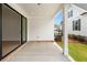 Covered outdoor patio features a concrete floor, brick trim, and a sliding glass door at 509 Pearl St, Cumming, GA 30040