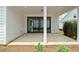 Covered patio with concrete flooring, brick skirting, and sliding glass doors at 509 Pearl St, Cumming, GA 30040