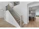 Beautiful staircase with wood treads, black iron railings, and light-colored walls and floors at 509 Pearl St, Cumming, GA 30040