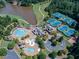 Aerial view of community with pools, tennis courts, and playground at 879 Big Horn Hollow, Suwanee, GA 30024