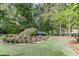 Landscaped backyard with a relaxing seating area nestled amongst the trees at 879 Big Horn Hollow, Suwanee, GA 30024