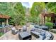 Spacious backyard patio with seating area, pergola, and built-in grill at 879 Big Horn Hollow, Suwanee, GA 30024