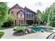 Beautiful backyard featuring a swimming pool, patio, and lush landscaping at 879 Big Horn Hollow, Suwanee, GA 30024