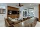 Spacious basement recreation room with sectional sofa and built-in entertainment center at 879 Big Horn Hollow, Suwanee, GA 30024
