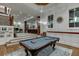 Finished basement features a pool table, comfortable seating, and hardwood floors at 879 Big Horn Hollow, Suwanee, GA 30024